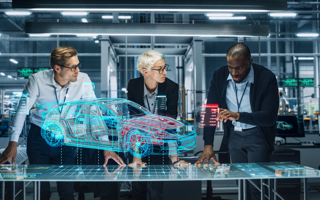 Engineers reviewing a holographic car model, illustrating software-defined vehicles